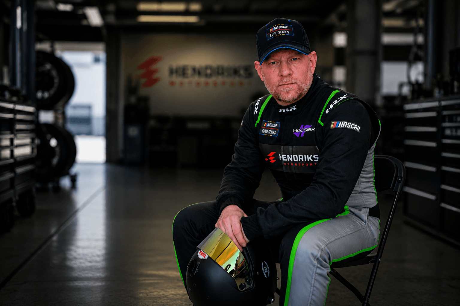 Henrik Peters in the Hendriks Motorsport garage holding his helmet