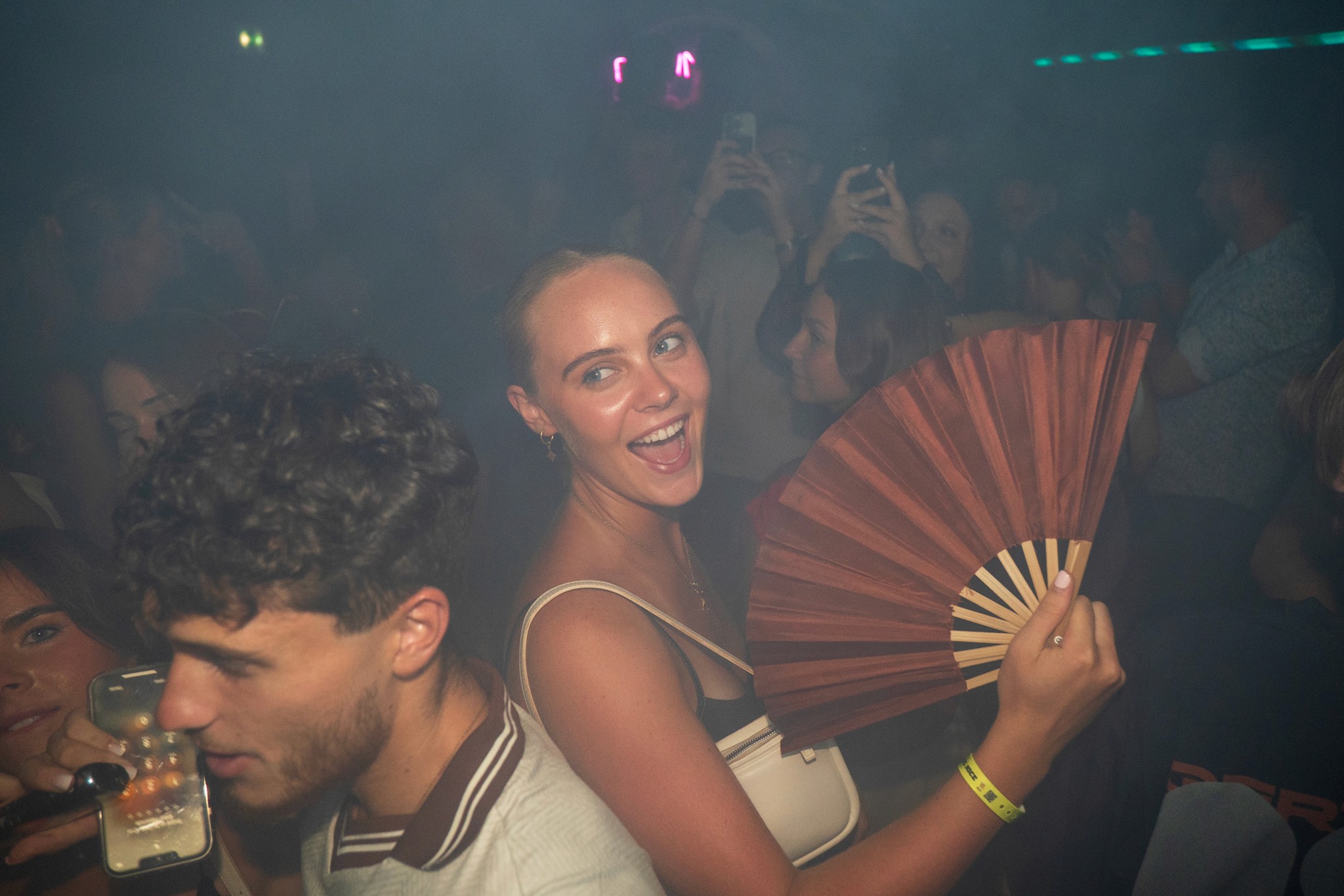 Young solo travelers enjoying a high energy moment on a crowded dance floor during a bar crawl in Nice with loud music party lights and a vibrant nightlife atmosphere capturing connection freedom and spontaneous fun on the French Riviera