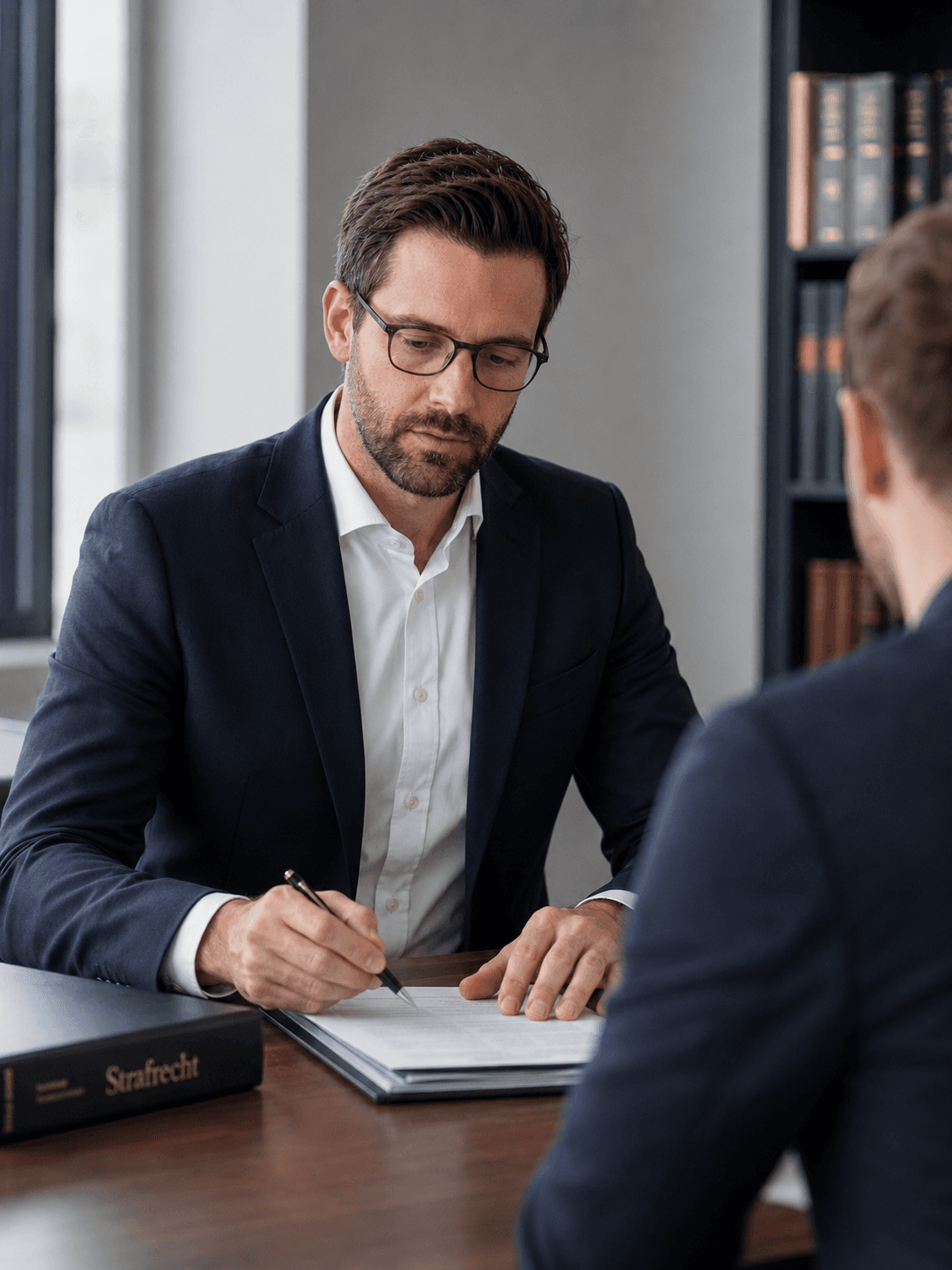 A man in a dark blazer in an office environment