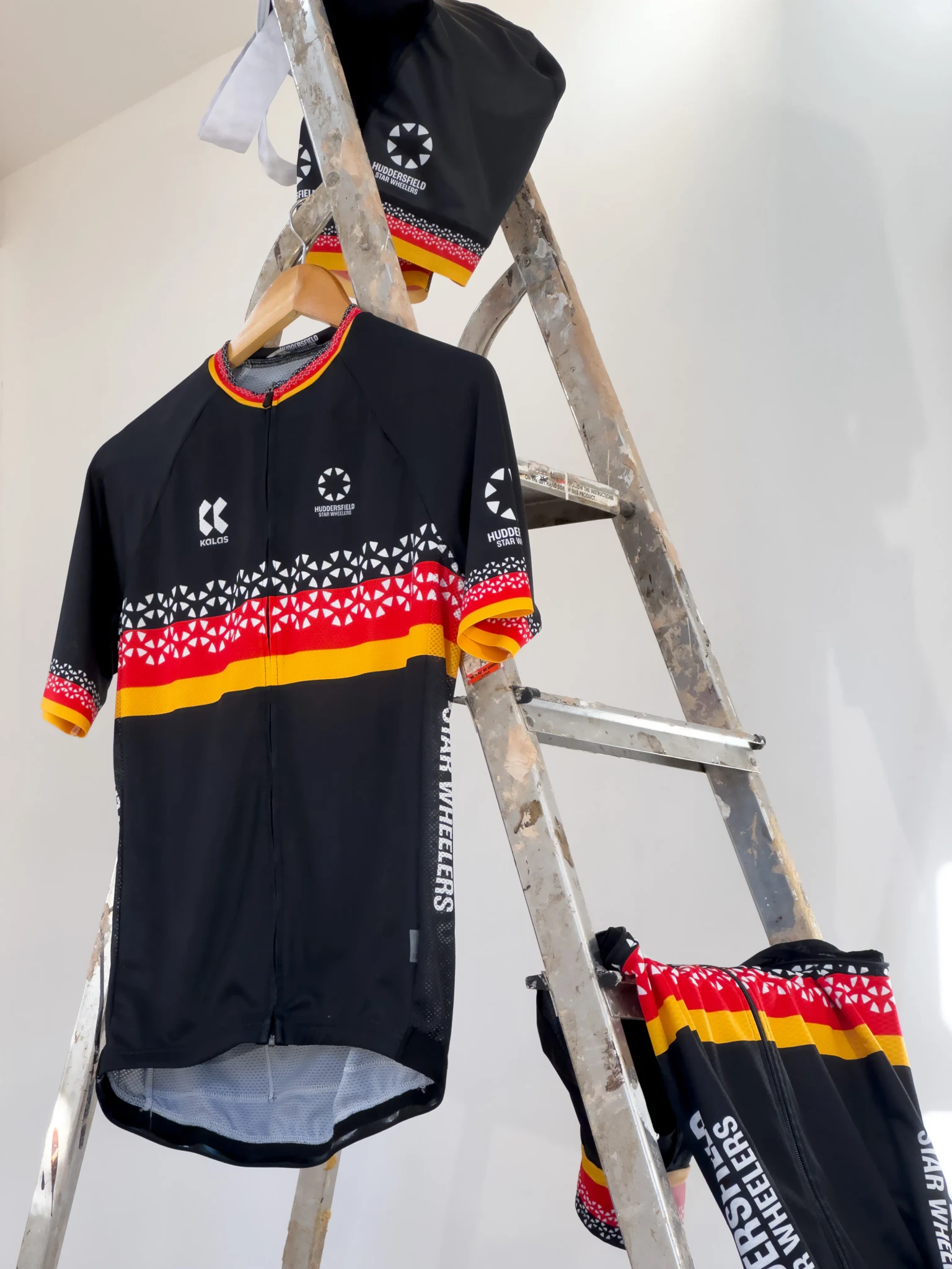 Star Wheelers gilet, jersey and bib shorts hanging on a stepladder