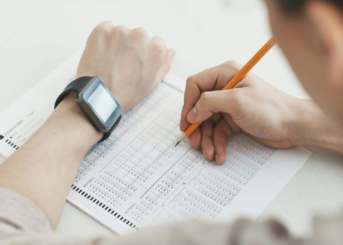 Woman using a biohacking device to track her vitals on a piece of paper