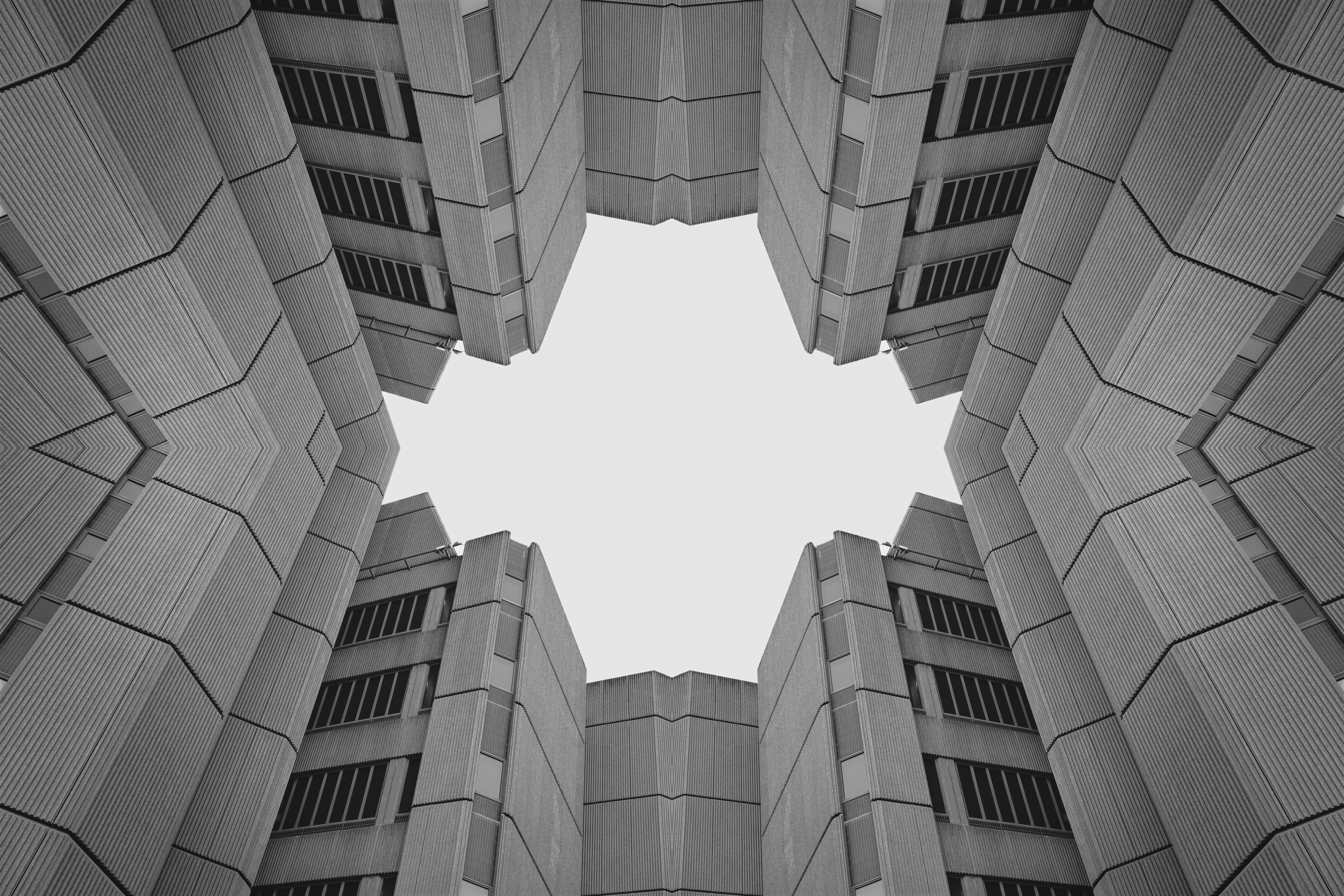 Symmetrical view of modern buildings against sky