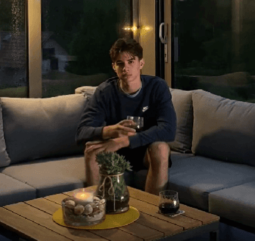 An asian person in a dark area with a sunlight on him