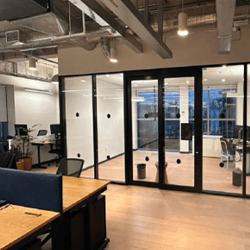 Contemporary interior with sculpted angled walls and a skylight filling the space with natural light.
