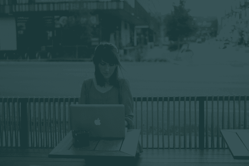 Woman focused on work while typing on a laptop