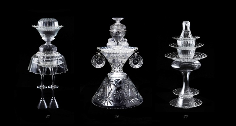 A photo of three glass objects that look like figurines.