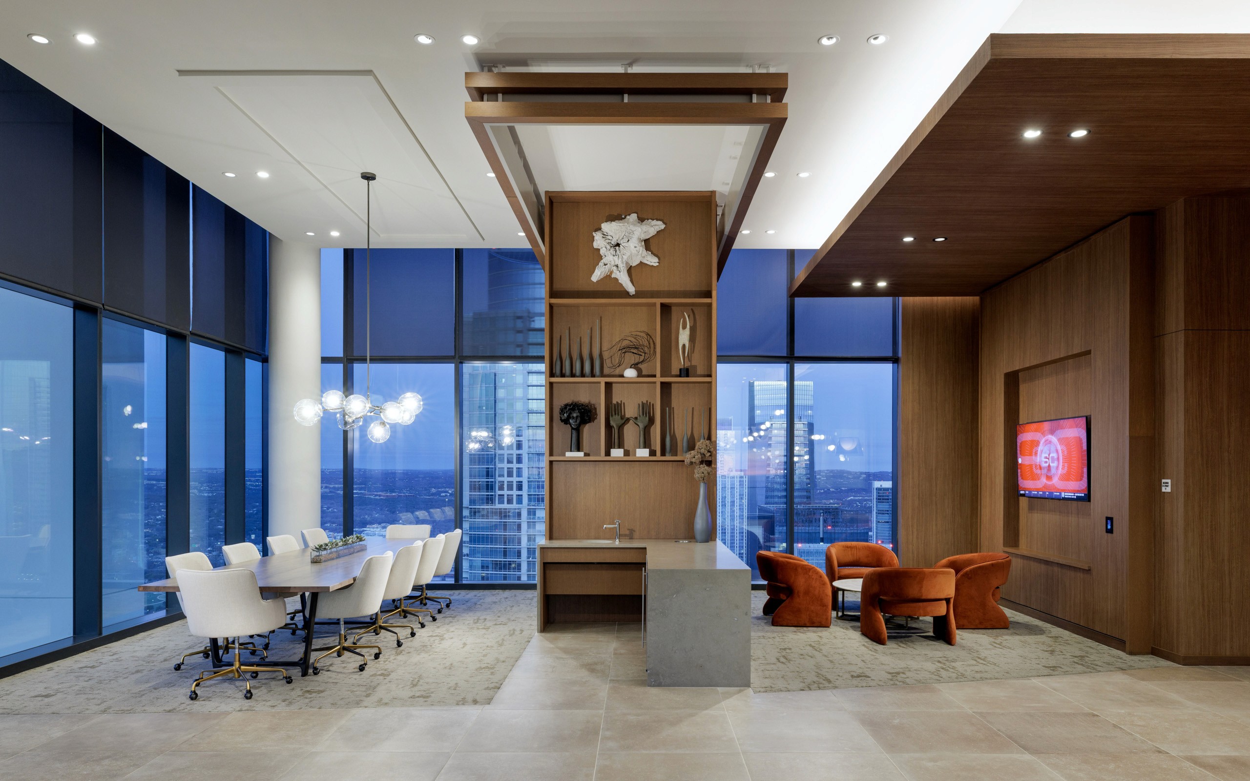 Modern conference room with city view and seating areas.