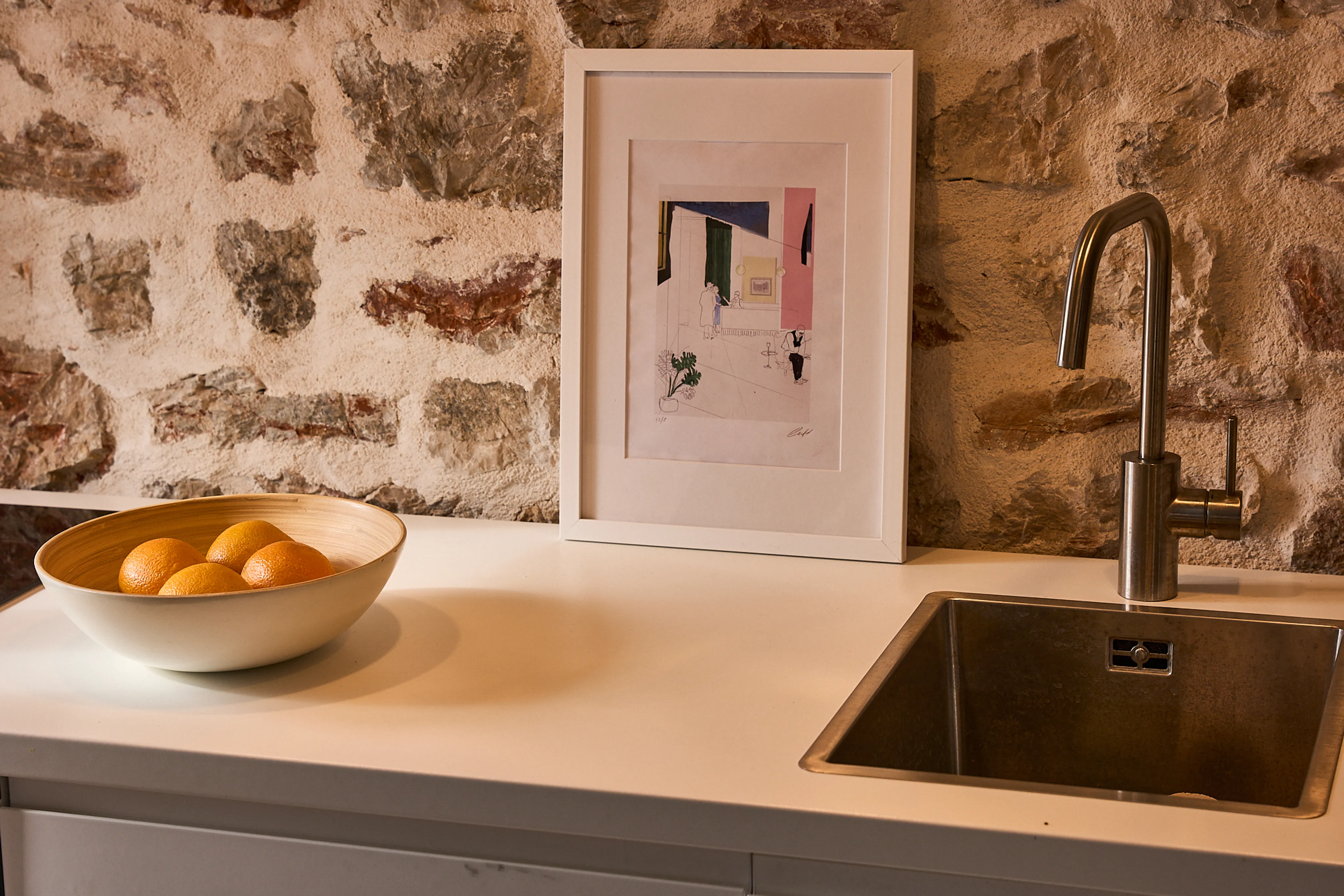 Kitchen detail with stone wall and artwork in the Amanda Suite, Hidden House, Stari Grad Hvar