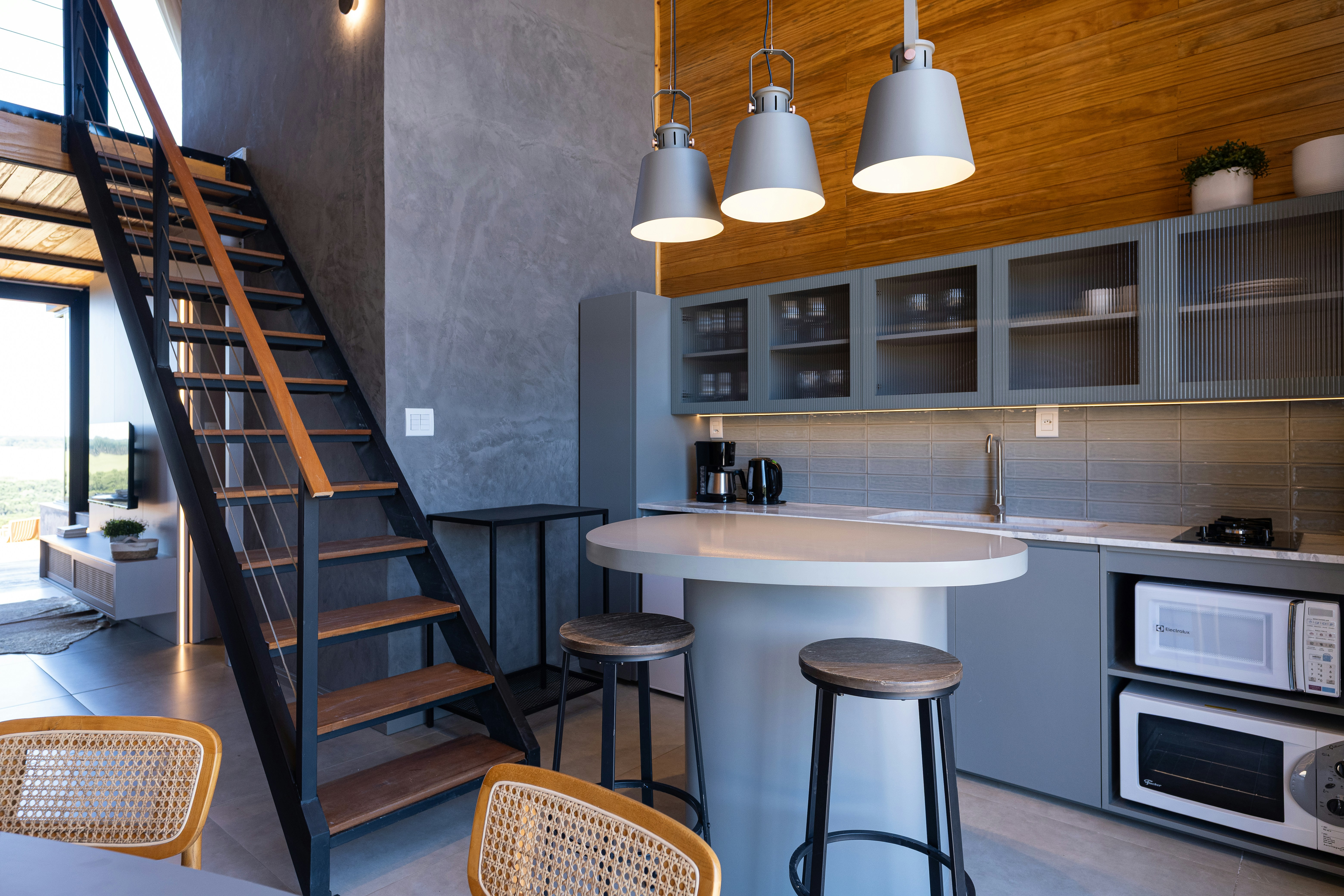 Modern kitchen with island and industrial staircase