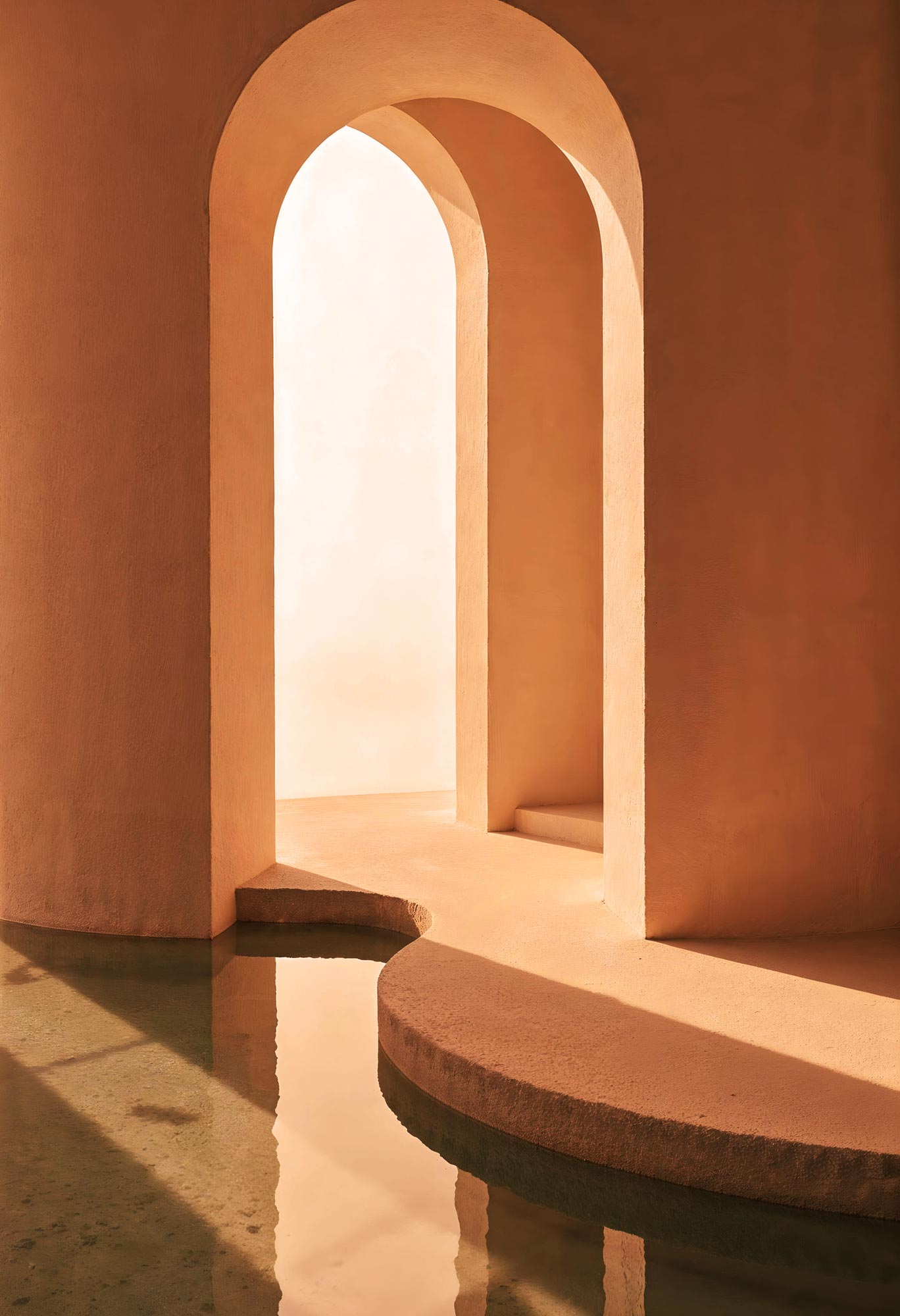 Terracotta arches with curved steps and a reflective water basin illuminated by warm light.