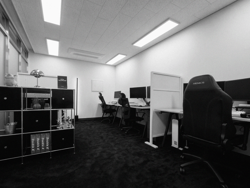 Three people in conversation with warm lighting, including a person wearing a hat and another person wrapped in what appears to be a textured shawl or sweater.