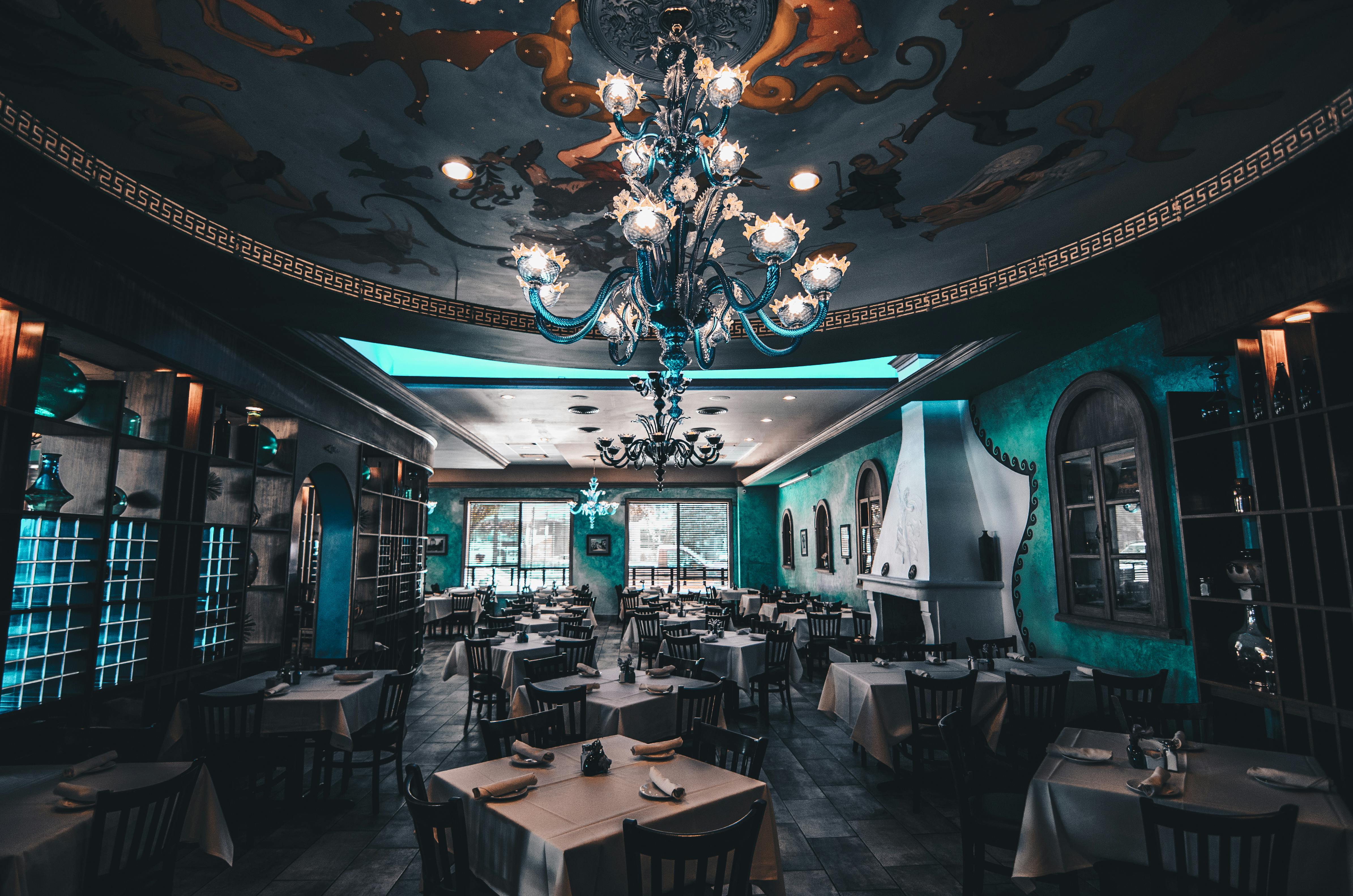 luxury restauarant interior in blue colors with large chandelier