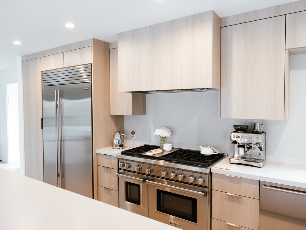 light oak look kitchen cabinetry with built in appliances