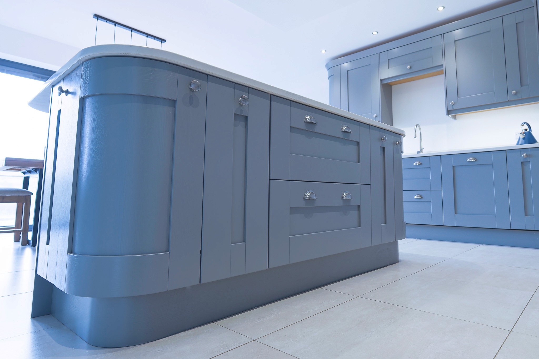 blue shaker kitchen island with curved edges