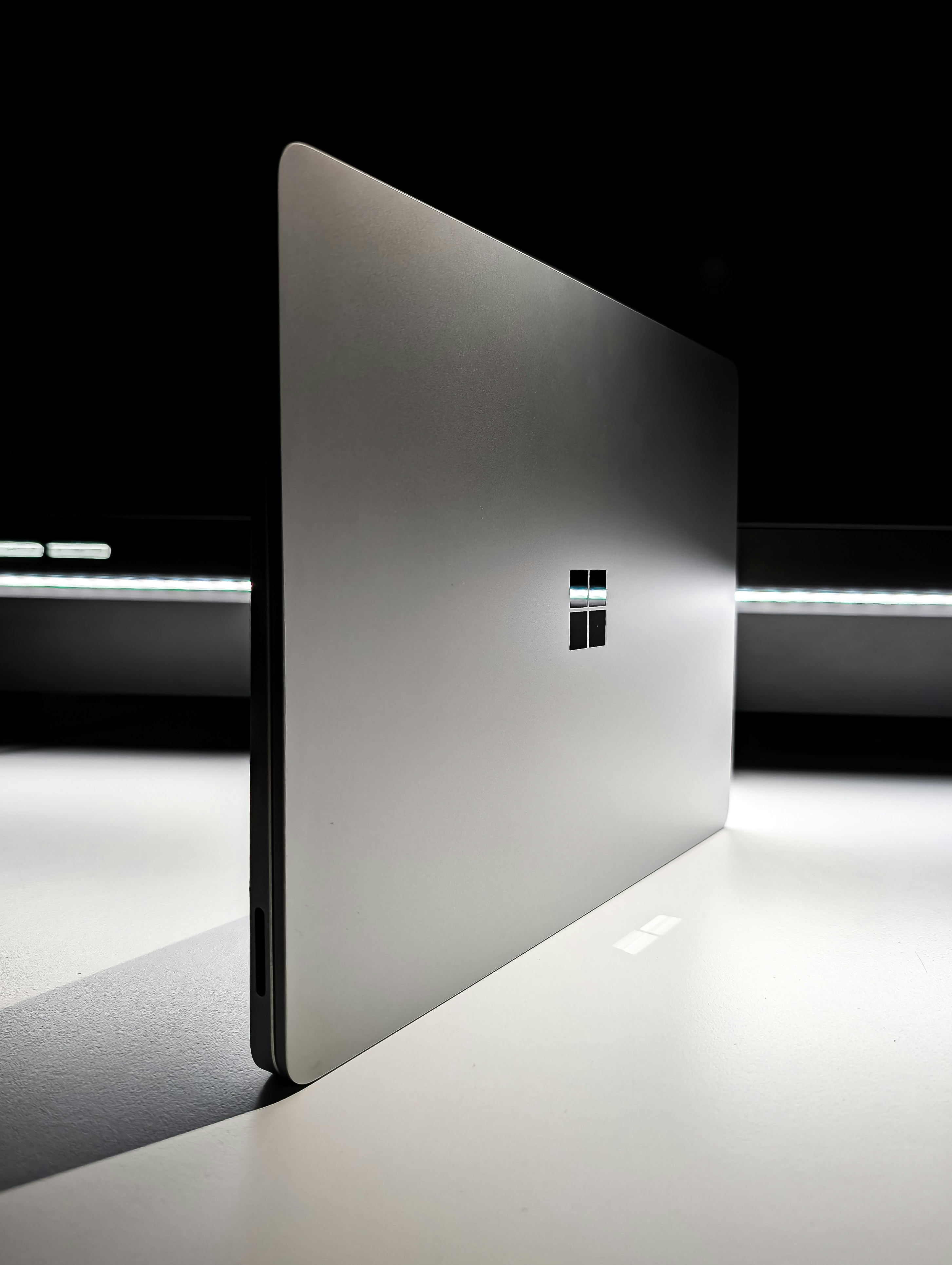 A laptop computer sitting on top of a white table