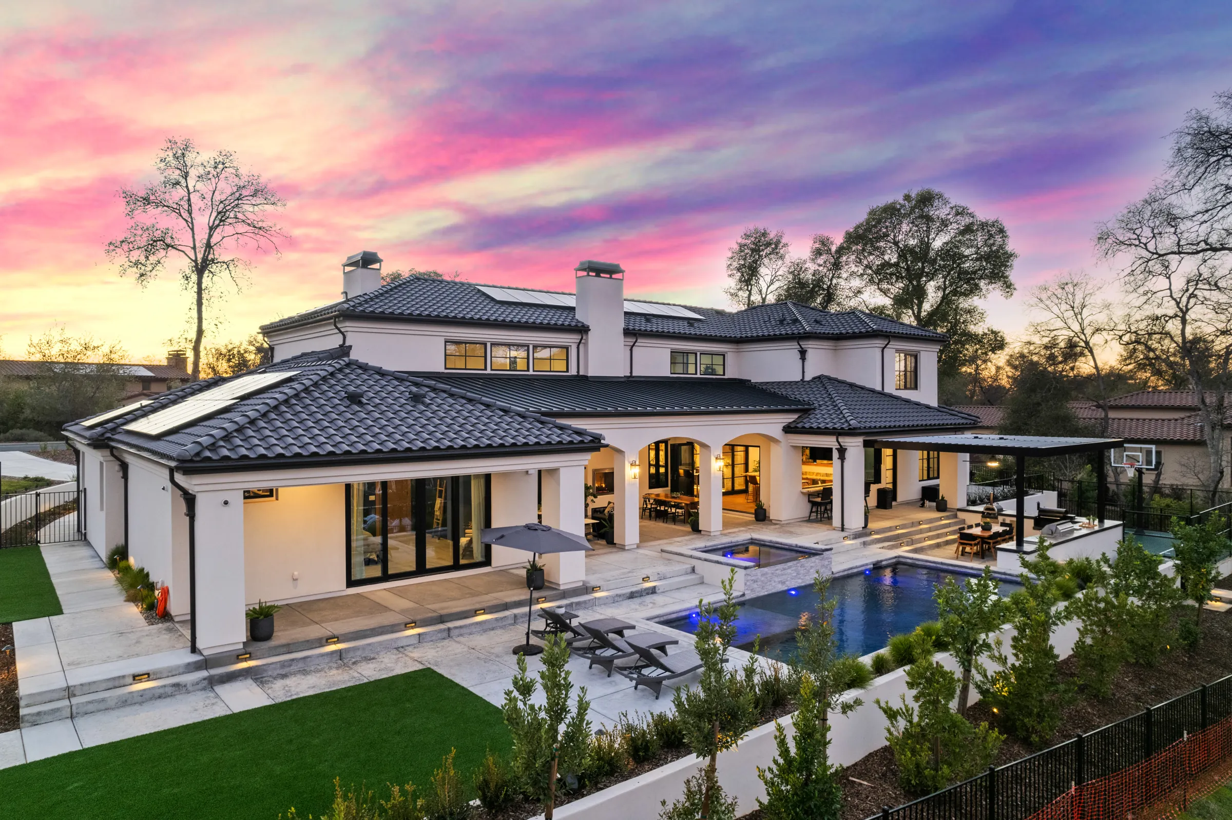 aBackyard pool and covered patio on a custom home built by ERC
