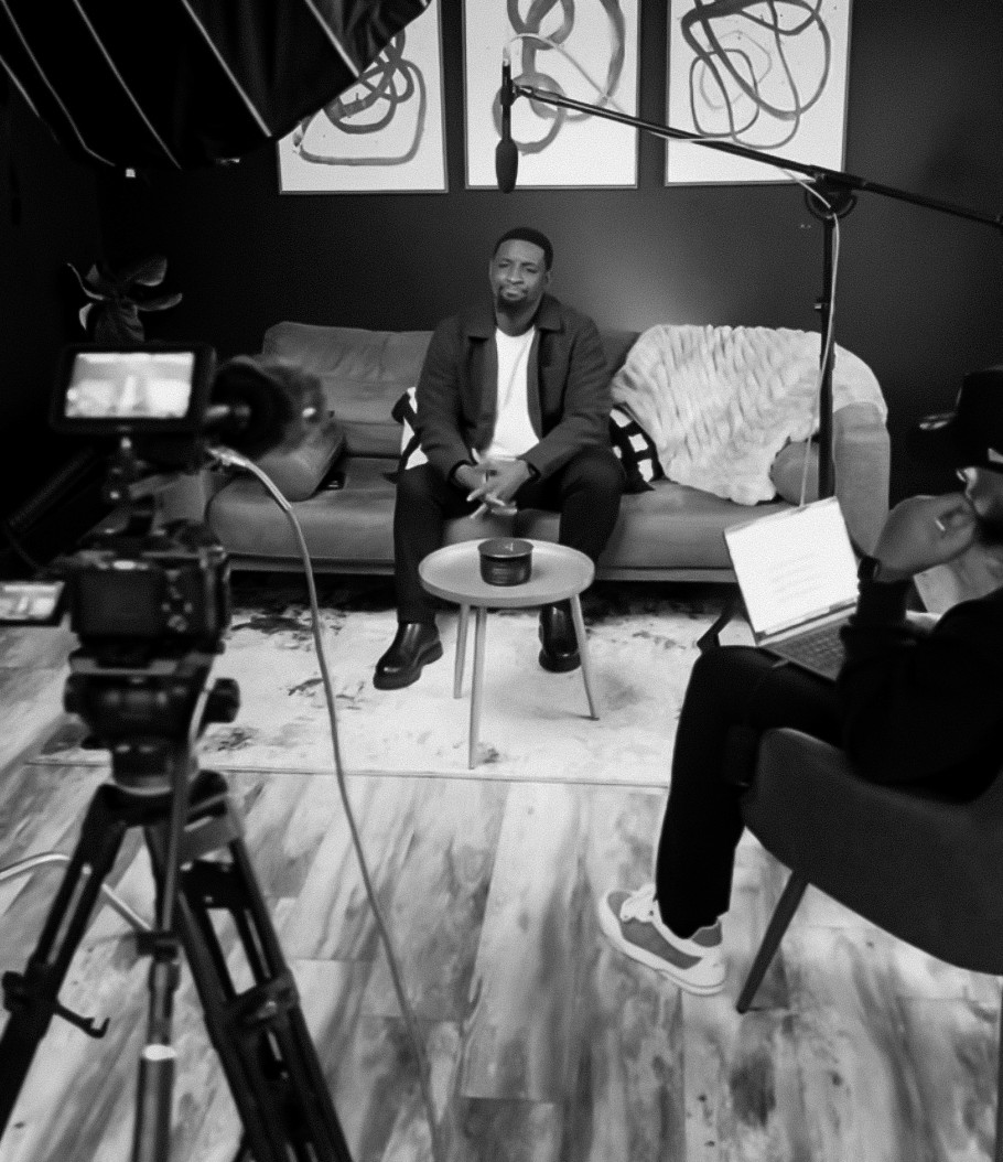 a person wearing a helmet and a cloak with a plain gradient background