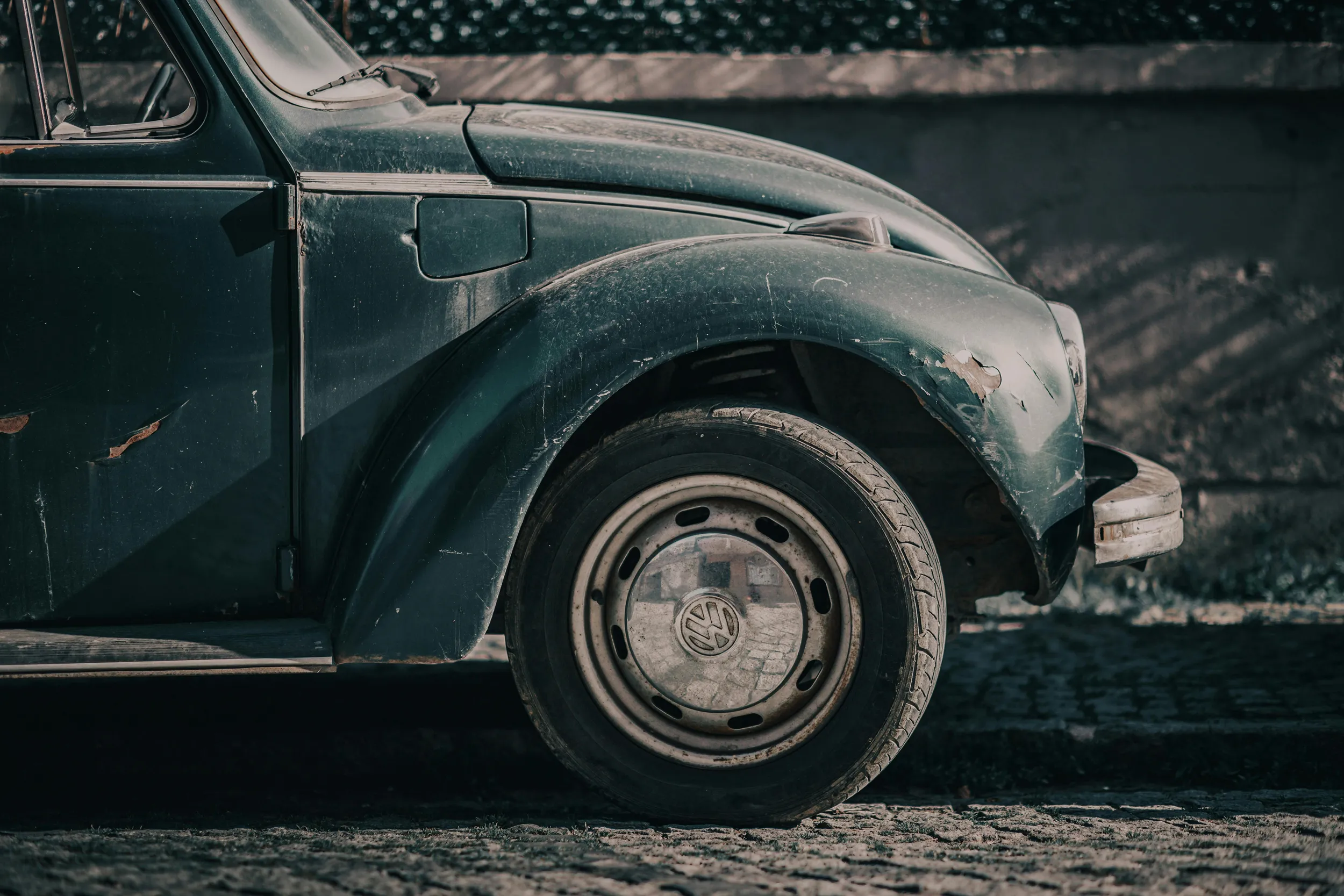 Close-up of classic vintage car front wheel and fender, retro automotive photography