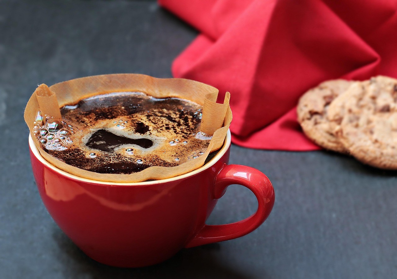 white ceramic cup with saucer and stainless steel spoon