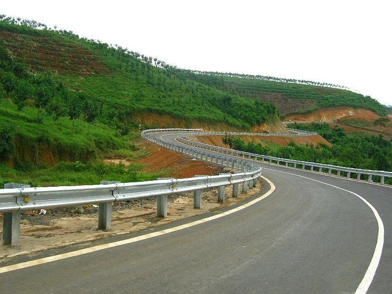 An excavator works on a construction site with a person.