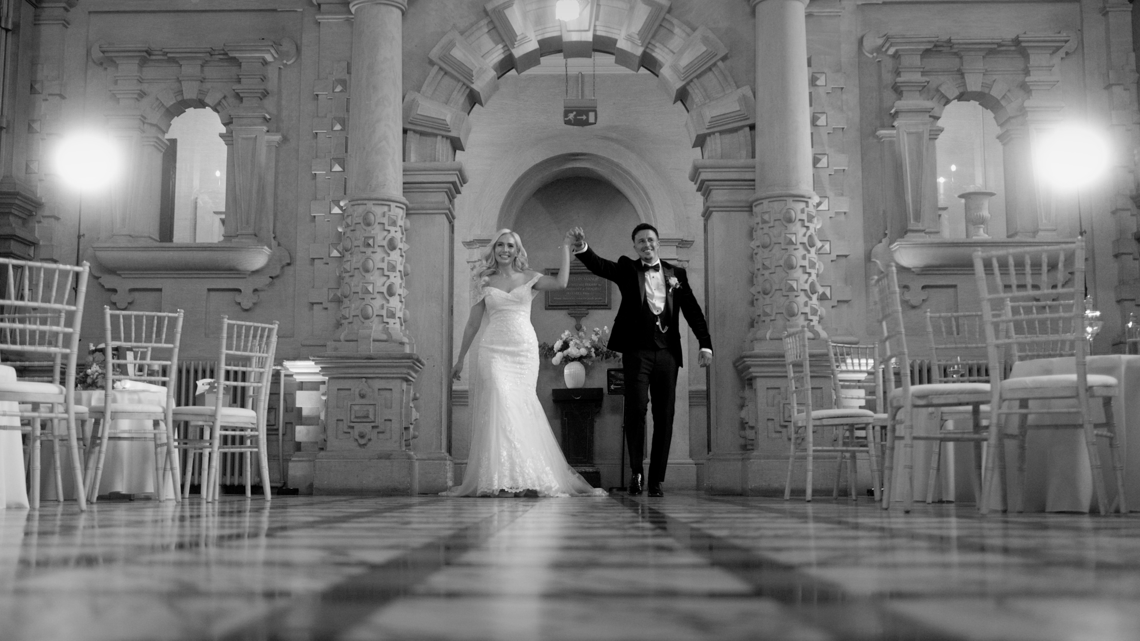 Bride and groom entering the reception together for their first dance inside Harlaxton Manor
