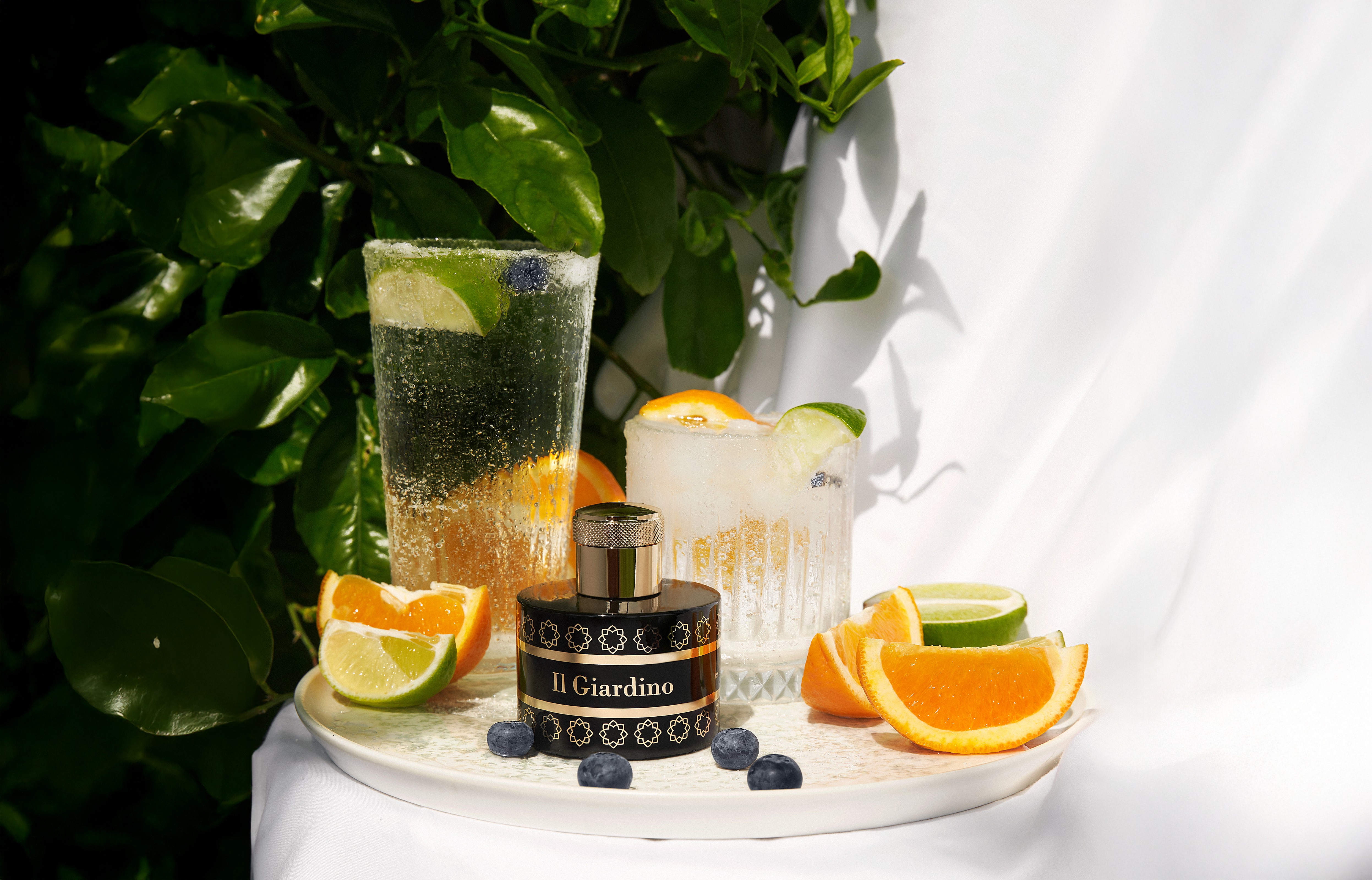 Close-up of two smiling friends with freckles, bright makeup, on a light blue background—joyful, inclusive brand portrait.