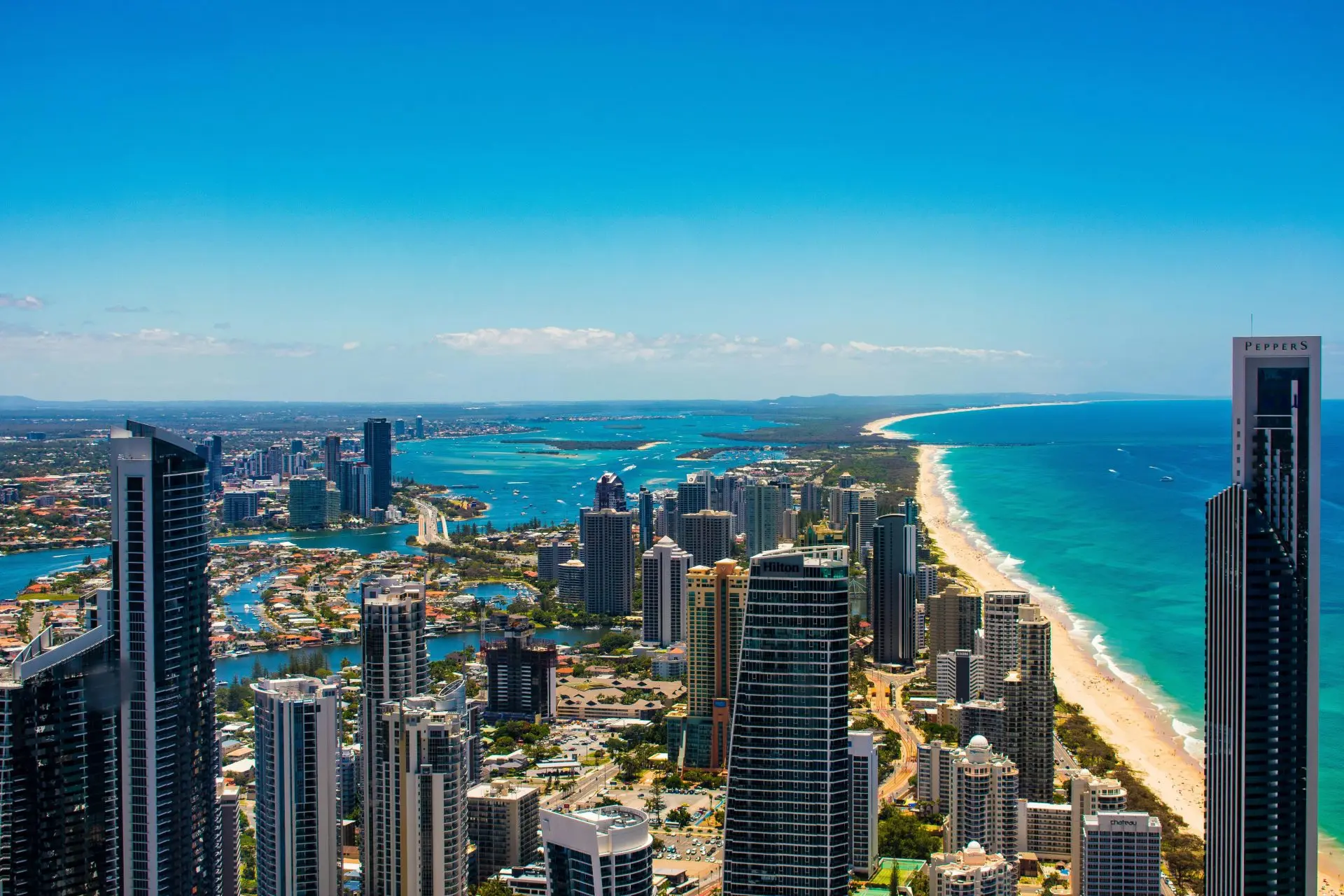 Coastal city skyline with high-rise buildings and a beach