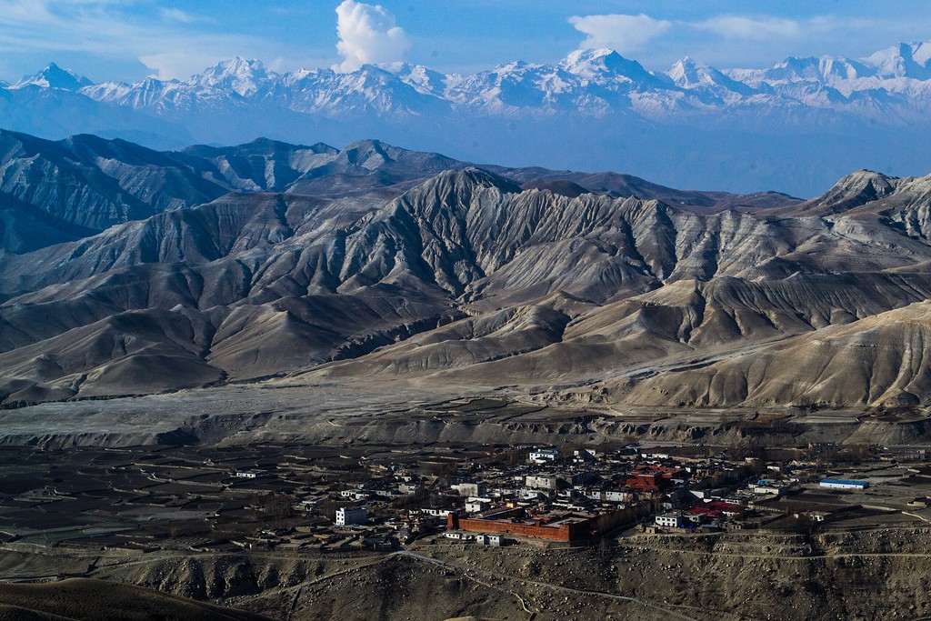 a view of a city and mountains from a distance