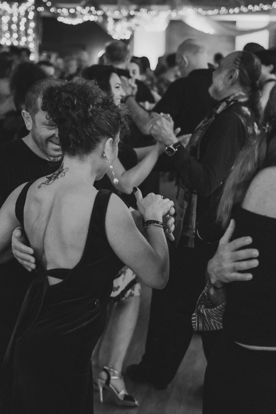 Black-and-white photograph of dancing guests
