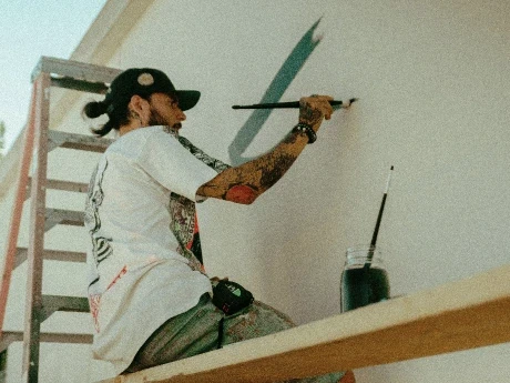 four orange, green, blue, and red paint rollers