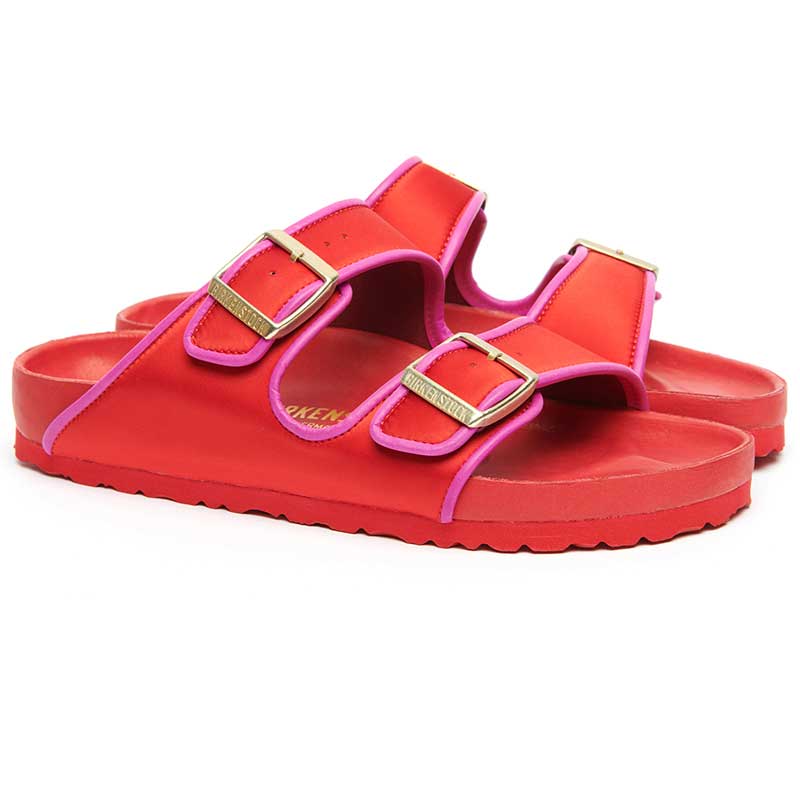 Red Birkenstock Arizona sandals with pink piping — vivid and luxurious, captured in styled travel-inspired layouts.