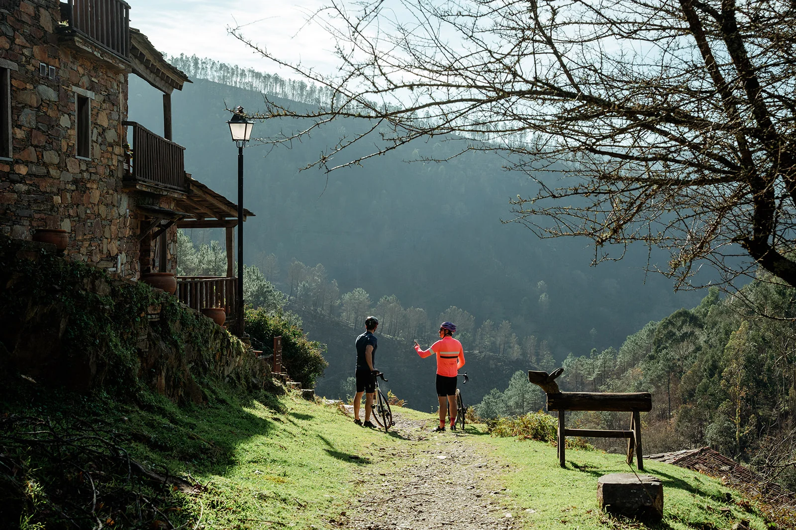 two cyclist speaking in a rural village