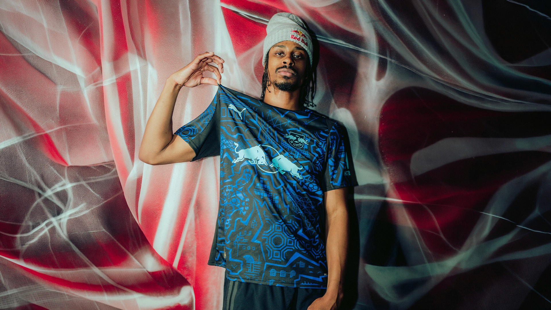 Stalamuerte dancing with RB Leipzig players Bakayoko and Lukeba at the Red Bull Training Center, Leipzig.