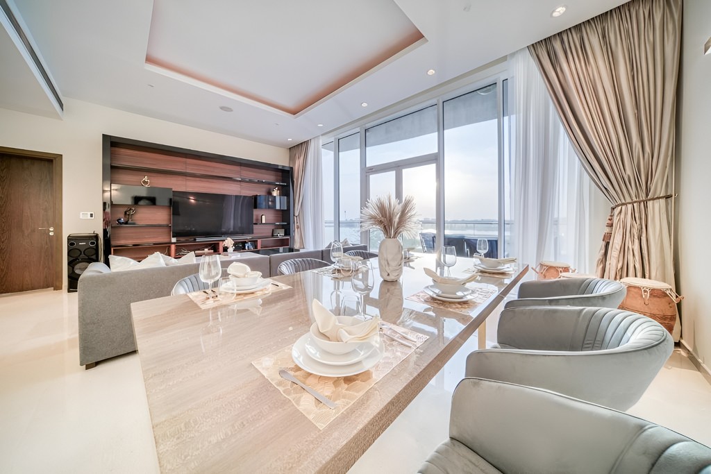 Interior view of a living room with a dining table and chairs, highlighting the stylish ambiance of Oceana Residences.