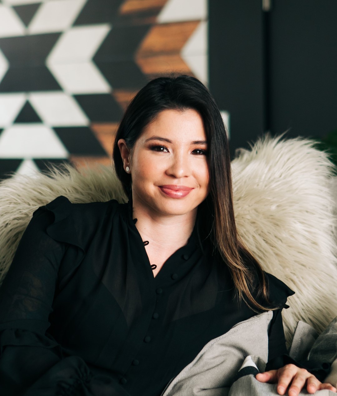 man in blue dress shirt and black pants standing near white wall