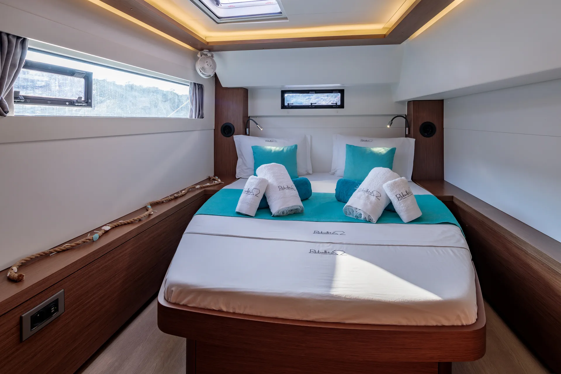 White Rock 36 speedboat with captain at helm cruising calm blue waters near Paros coastline with hills in background.