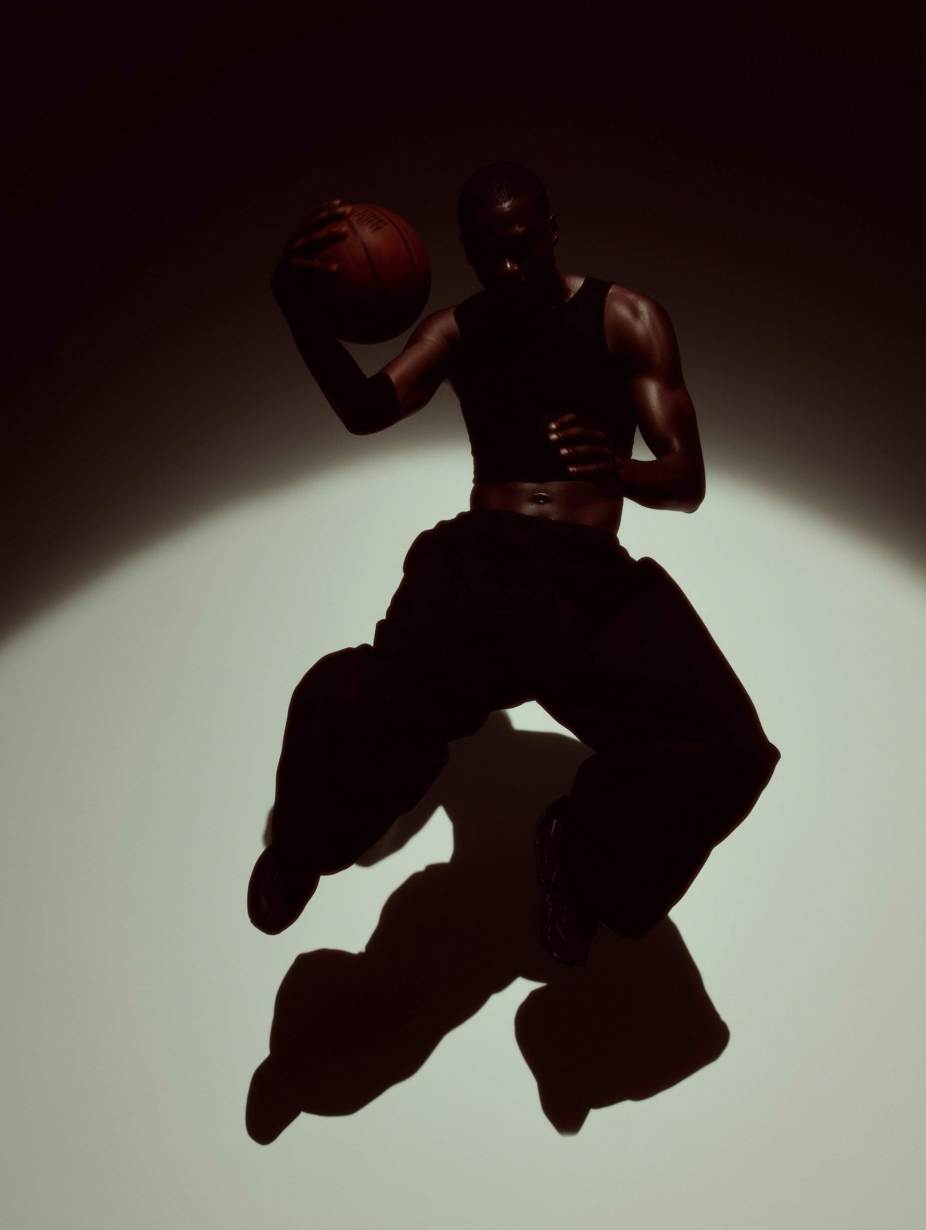 Basketball player jumping with ball 