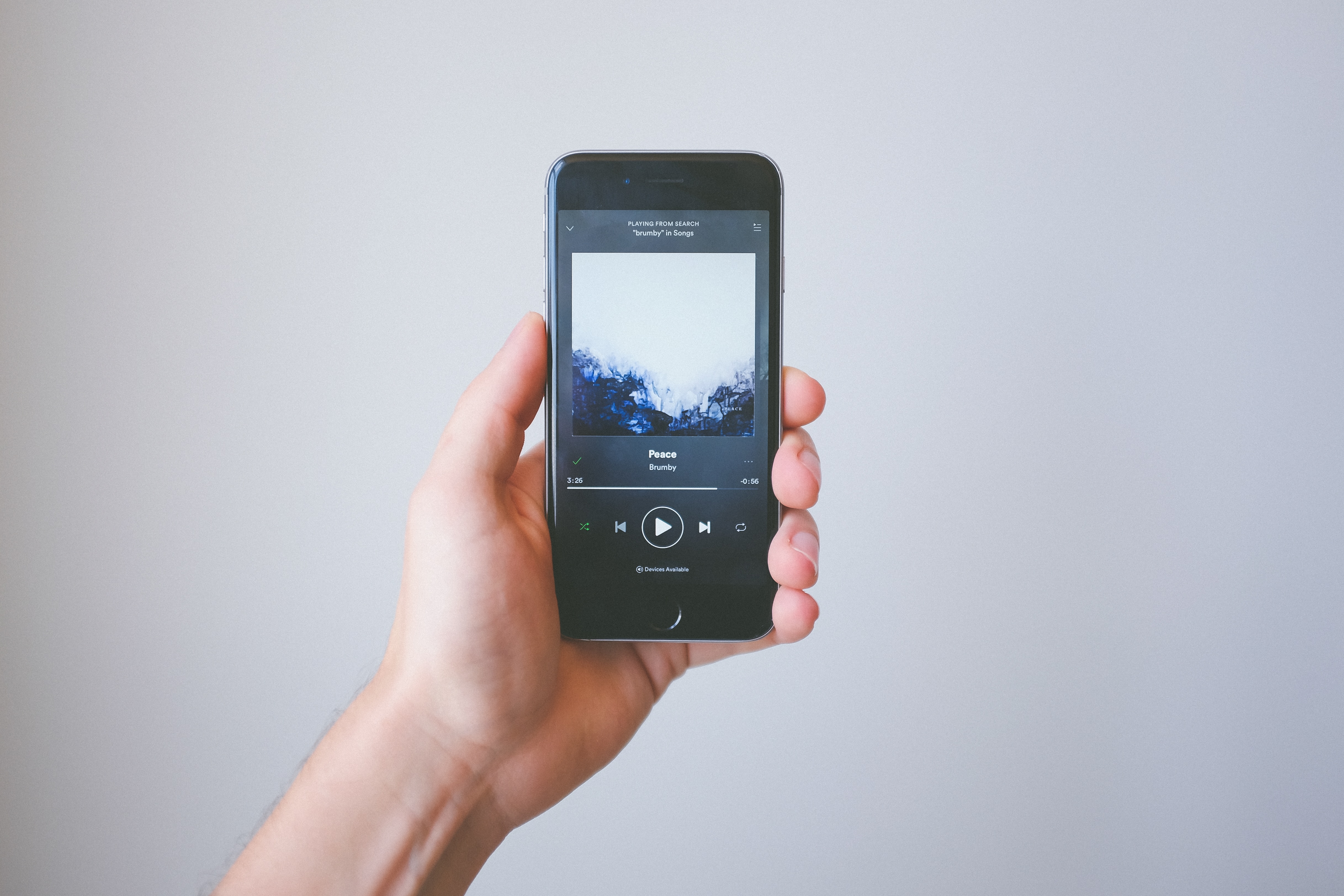 man holding a phone with music - how to write hit songs