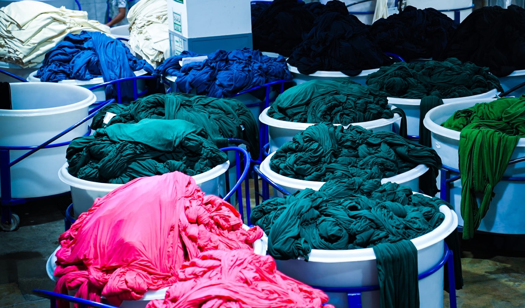 Fabric bundles in dye tubs.