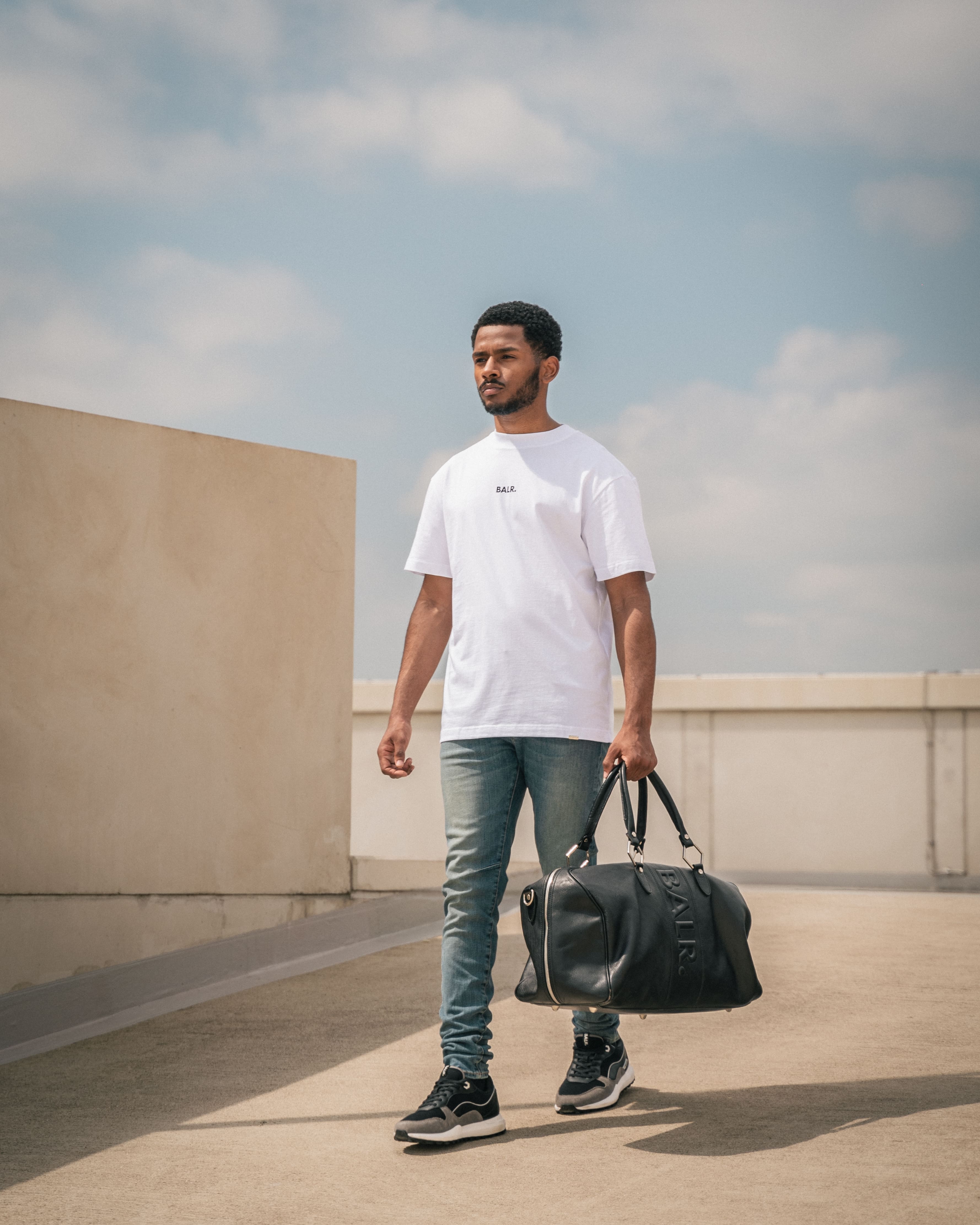 Streetside billboard with flyposters of the Batch.Works brand and illustrations