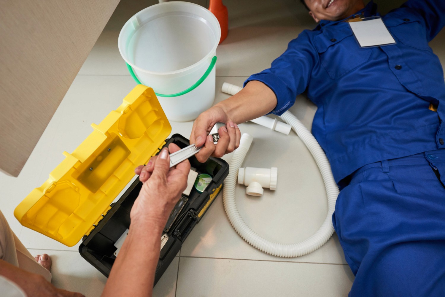 Ohana plumbing clearing a blocked drain at a house.