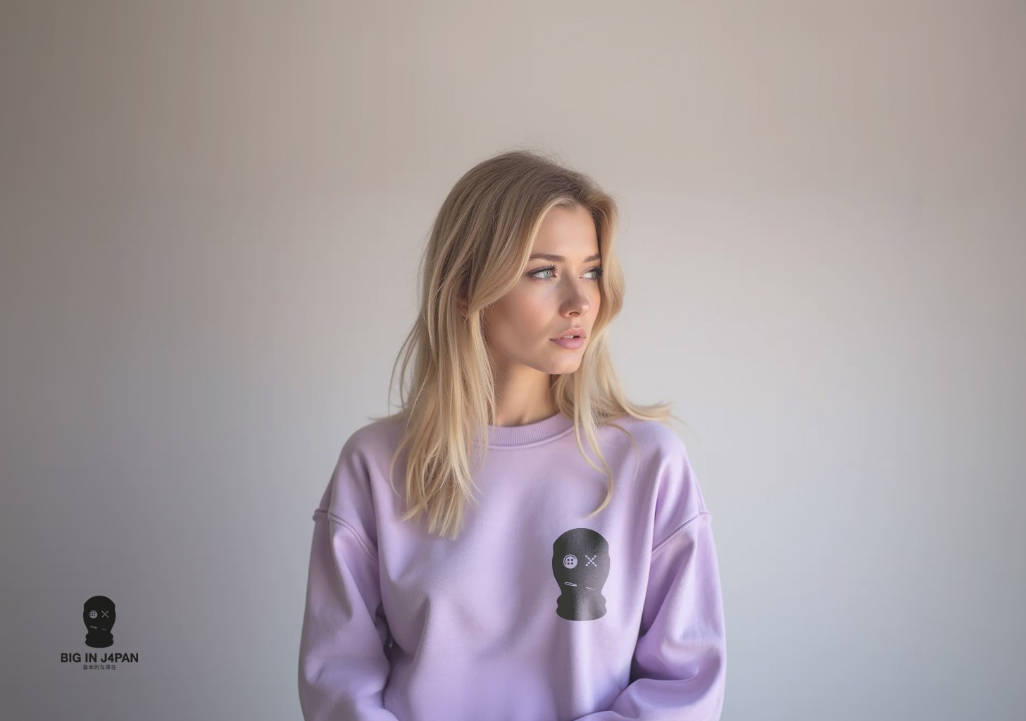 Very pretty young woman with faded lilac color sweater with Big In Japan logo on it