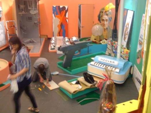 two persons working on installing golf course exhibition
