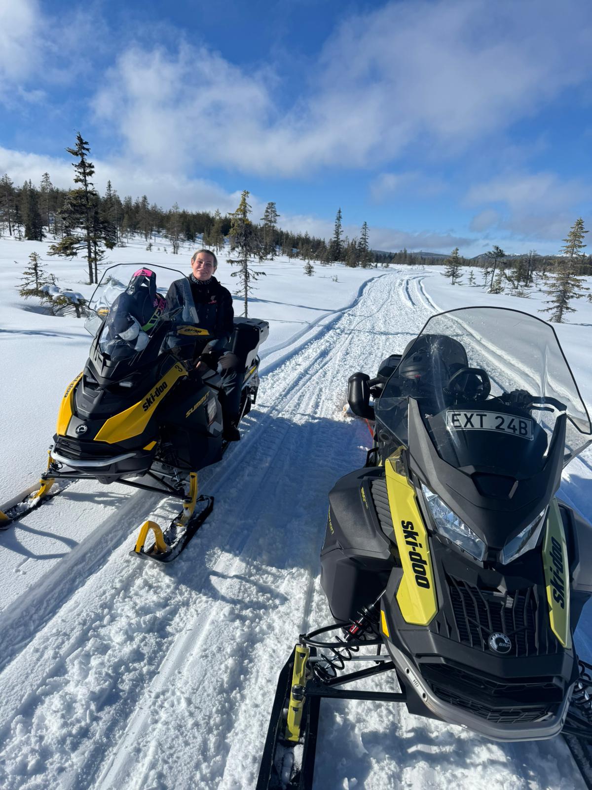 a snow covered street with houses and trees