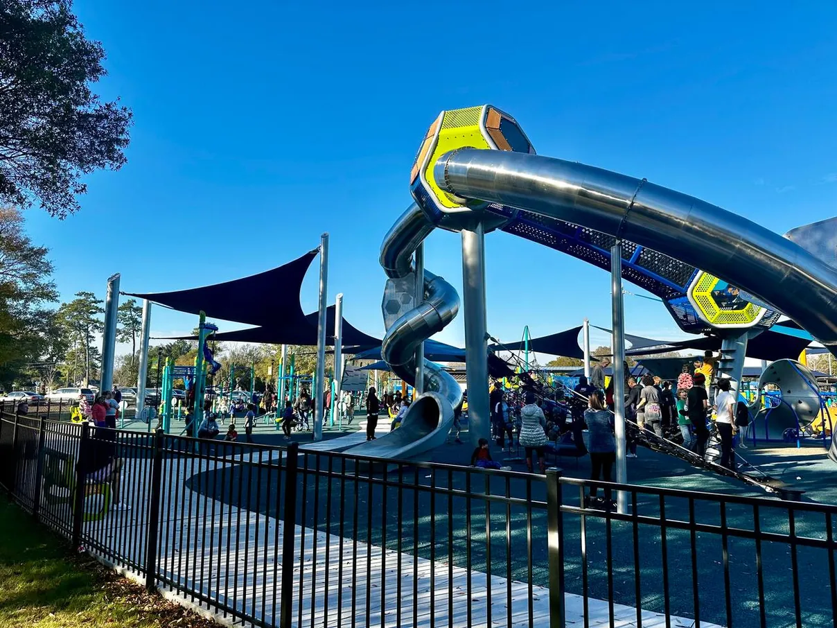 The inclusive playground inside Park Circle, with slides under shade sails