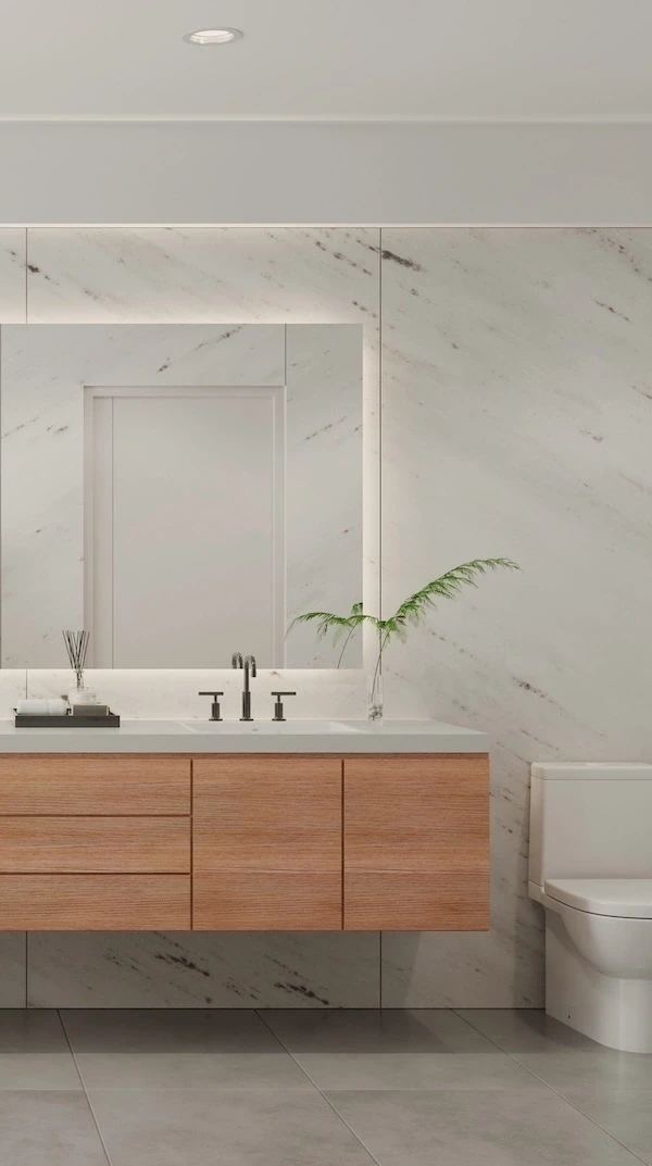 Bagno moderno luminoso con vasca freestanding, pareti in marmo chiaro e doppio lavabo sospeso in legno.
