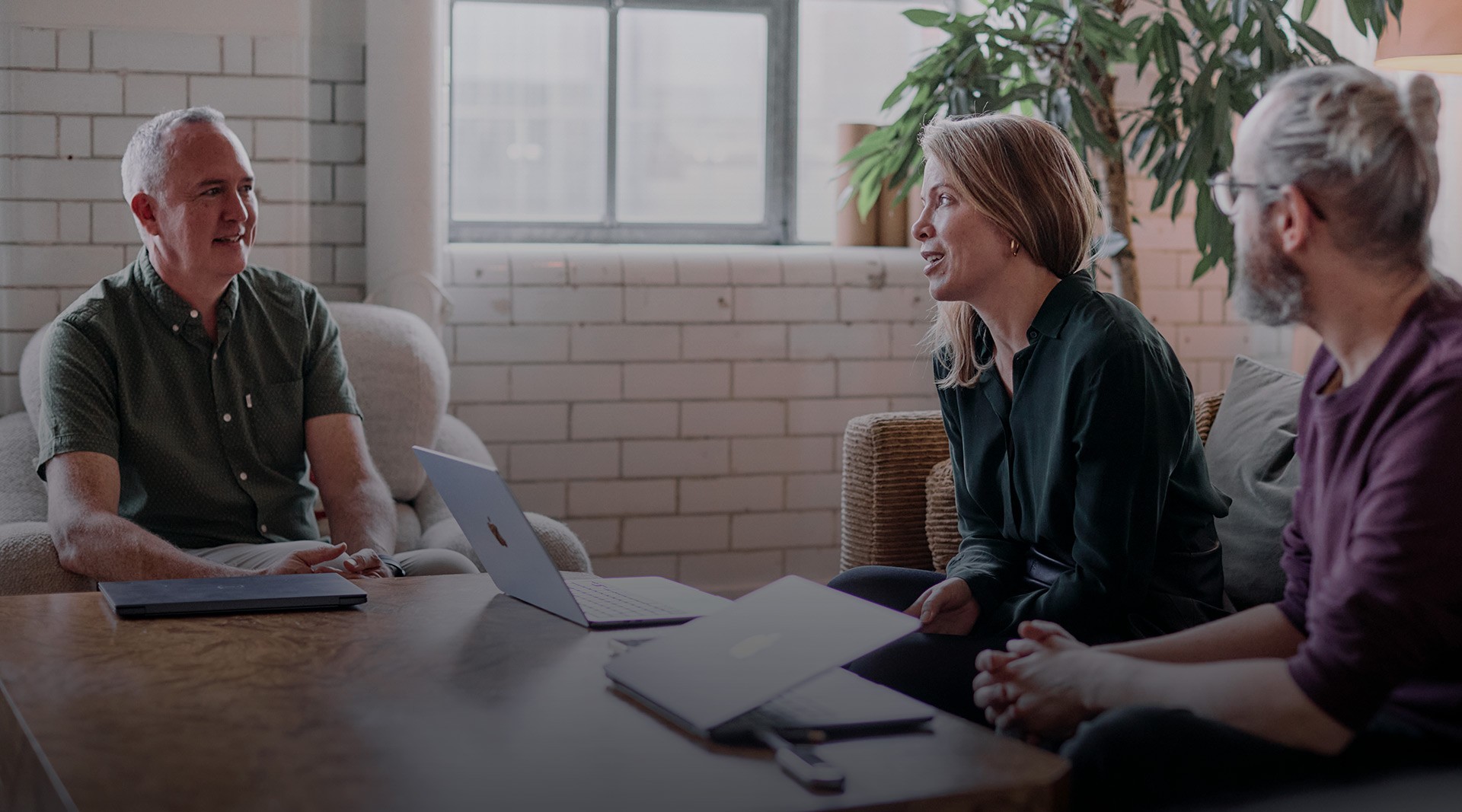 Thank you for getting in touch with Valliance header image of three of the team in discussion around their laptops