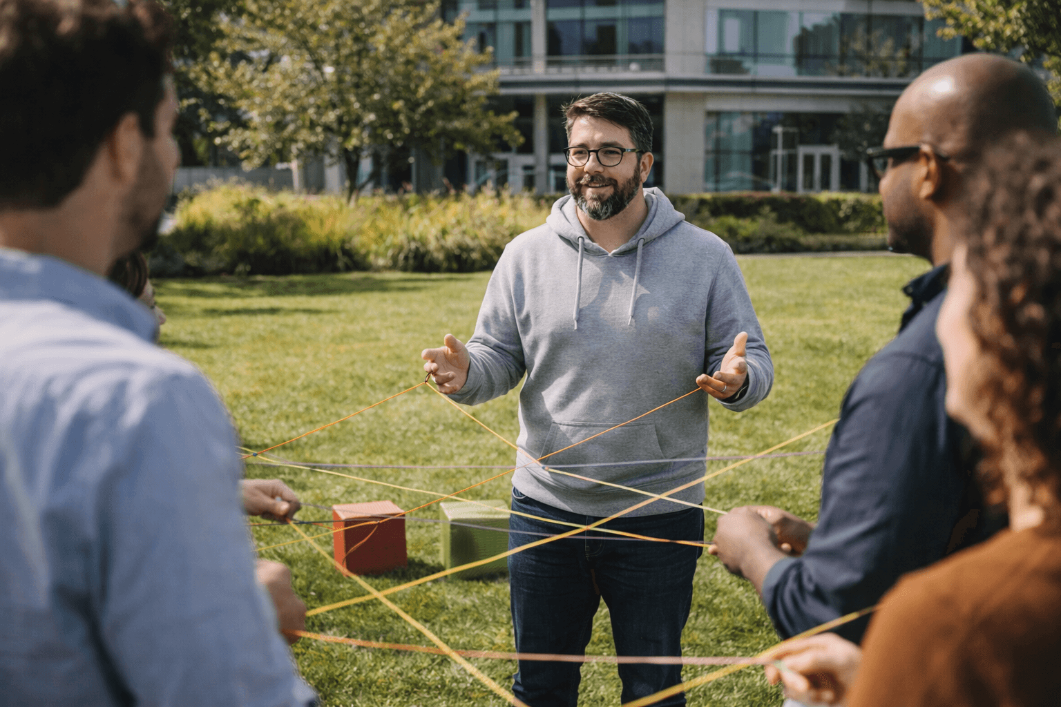 man wearing gray polo shirt beside dry-erase board