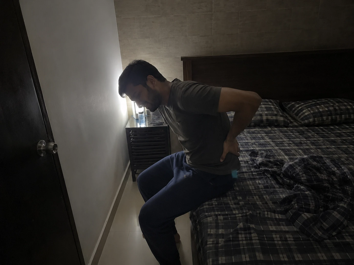 Man clutching his back in pain