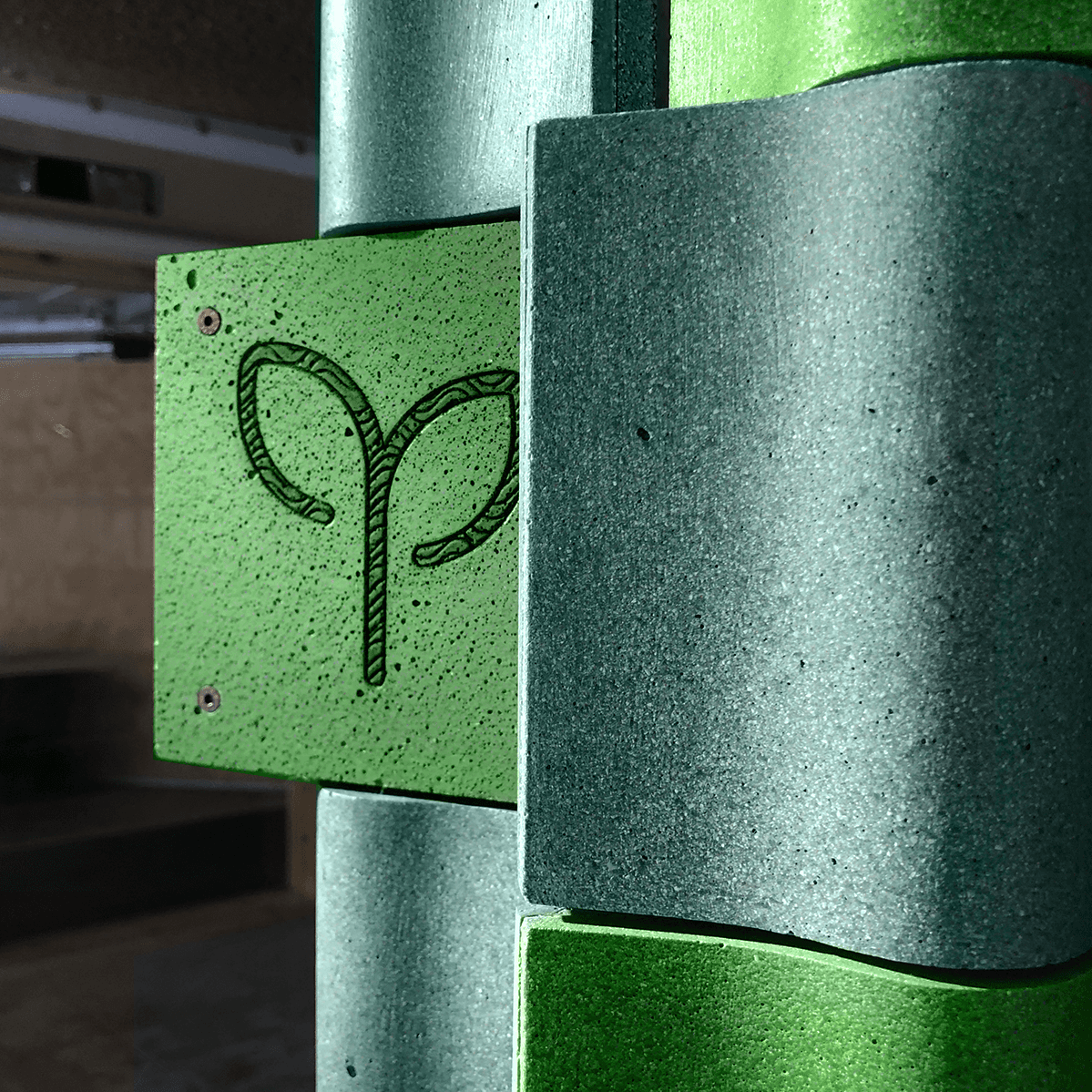 Close-up of recycled composite tiles mounted on an aluminum structure as part of the DIAPHRAGM urban installation project.